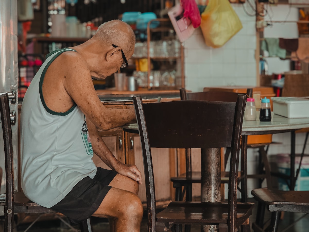 An older regular sitting at his usual table